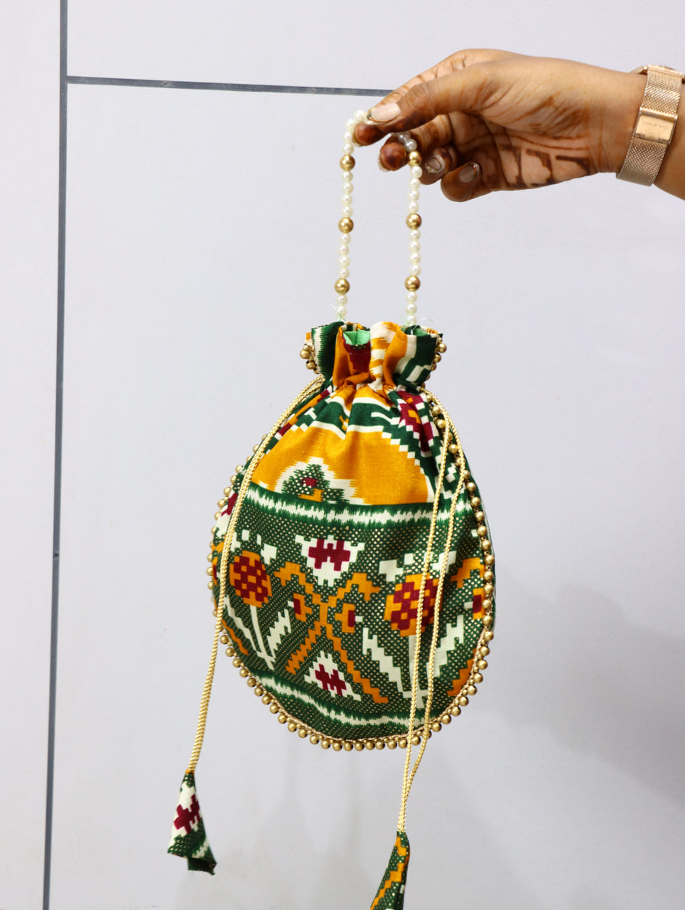 Premium Traditional Ikat Patola Potli Bag – Gold Bead Trim & Beaded Strap